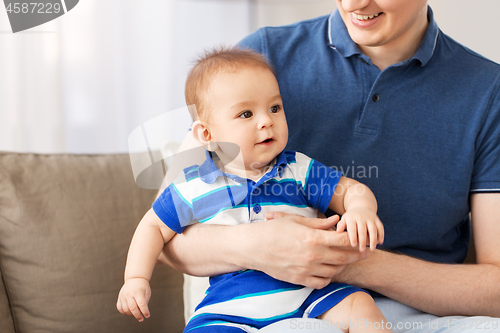 Image of happy baby son with father at home