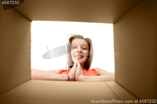 Image of happy girl looking into open gift box