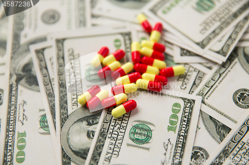 Image of close up of pills or drugs and dollar cash money