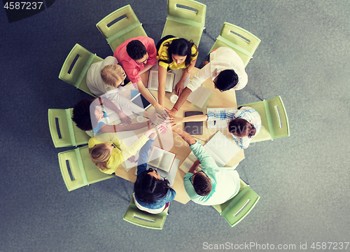 Image of group of international students with hands on top