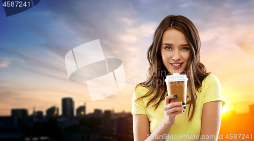 Image of young woman or teenage girl drinking coffee