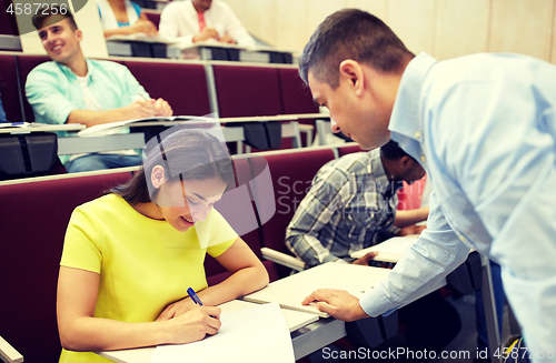 Image of group of students and teacher with notebook