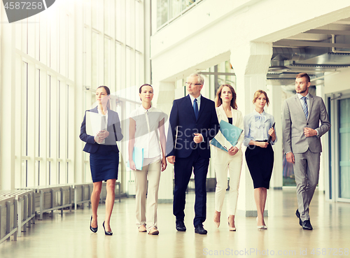 Image of business people walking along office building