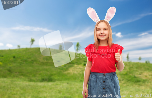 Image of girl wearing easter bunny ears showing thumbs up