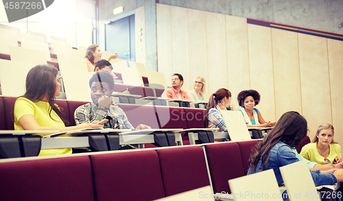 Image of group of students with notebooks at lecture hall