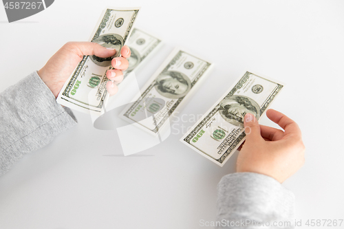 Image of close up of woman hands counting us dollar money