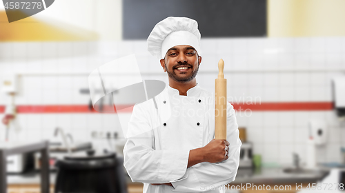 Image of baker with rolling-pin at restaurant kitchen