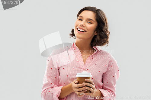 Image of happy young woman in pajama with cup of coffee