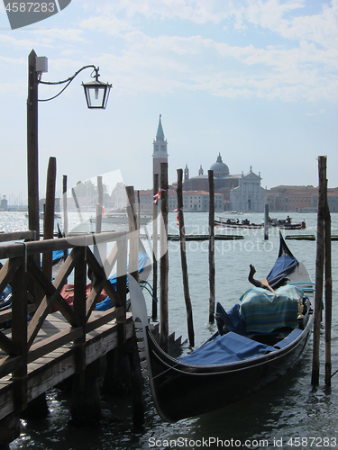 Image of Old wooden pier with parking italian tradition gondola.