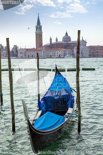 Image of Italian gondola parking on the water in Venice, Italia.