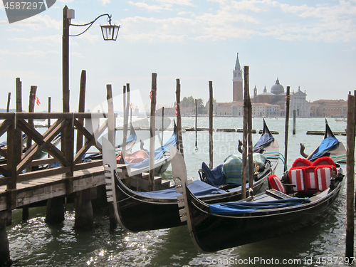 Image of Traditional italian gondolas parking near berth.