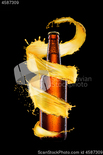 Image of Glass bottle with spiral beer splash.