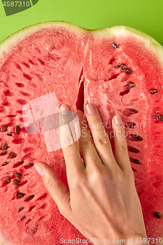 Image of Simulation of masturbation woman\'s finger inside ripe watermelon.