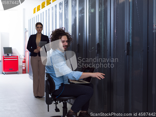 Image of Team of young technicians working together on servers