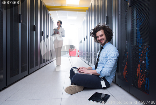 Image of Team of young technicians working together on servers