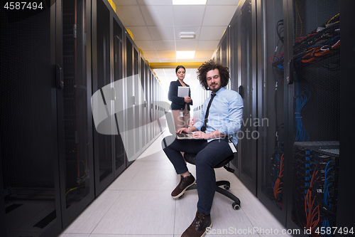 Image of Team of young technicians working together on servers