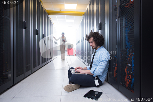 Image of Team of young technicians working together on servers