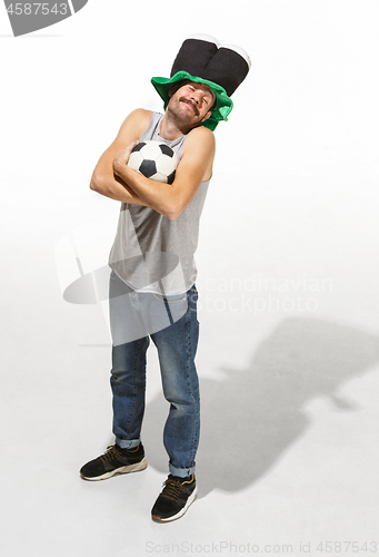 Image of The young football fan - man hugging soccer ball isolated on a white background