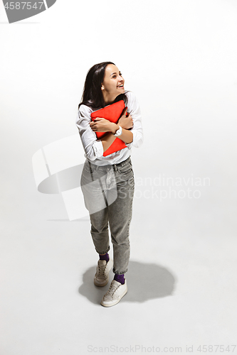 Image of Businesswoman hugging laptop. Love to computer concept.