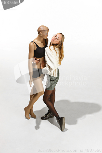 Image of Fashion woman body. The woman hugging mannequin, perfect woman dream concept