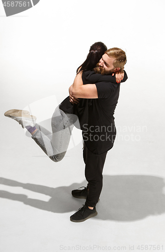 Image of Full body portrait of hugging couple with smile. Caucasian models in love