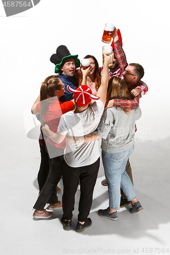 Image of Football fans hugging with beers on white background