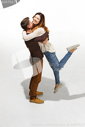 Image of Full body portrait of hugging couple with smile. Caucasian models in love