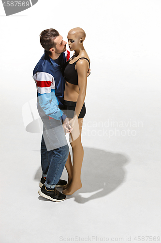 Image of Fashion woman body. The man hugging mannequin, perfect woman dream concept