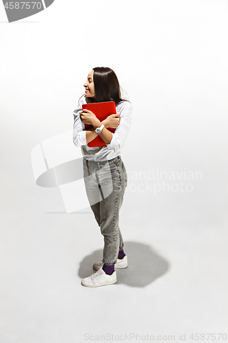 Image of Businesswoman hugging laptop. Love to computer concept.
