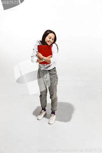 Image of Businesswoman hugging laptop. Love to computer concept.