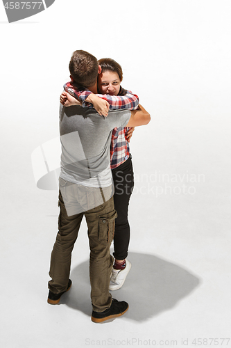 Image of Full body portrait of hugging couple with smile. Caucasian models in love