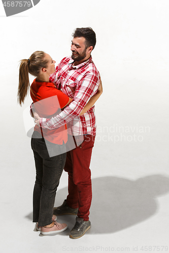 Image of Full body portrait of hugging couple with smile. Caucasian models in love