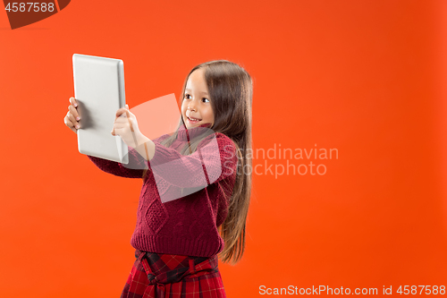 Image of Teen girl with laptop. Love to computer concept. Attractive female half-length front portrait, trendy studio backgroud.