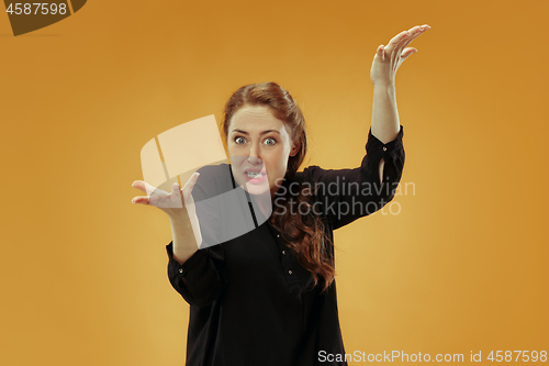 Image of Beautiful female half-length portrait isolated on studio backgroud. The young emotional surprised woman