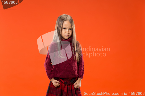 Image of Portrait of angry teen girl on studio background