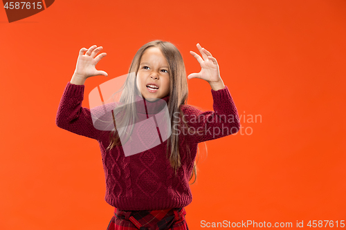 Image of Portrait of angry teen girl on studio background