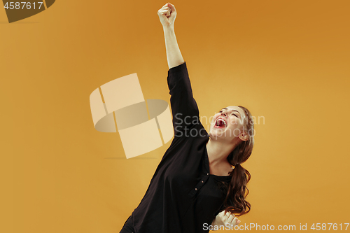 Image of Winning success woman happy ecstatic celebrating being a winner. Dynamic energetic image of female model