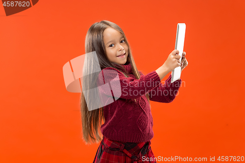 Image of Teen girl with laptop. Love to computer concept. Attractive female half-length front portrait, trendy studio backgroud.