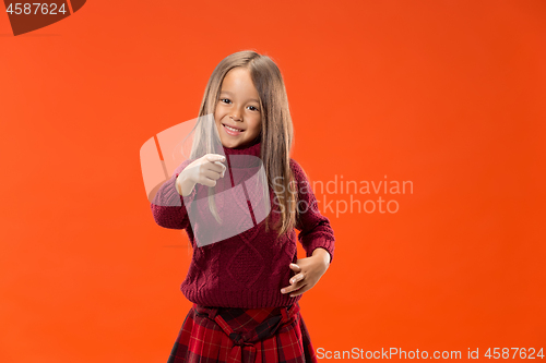 Image of The happy teen girl pointing to you, half length closeup portrait