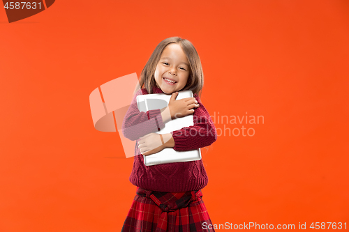 Image of Teen girl with laptop. Love to computer concept. Attractive female half-length front portrait, trendy studio backgroud.