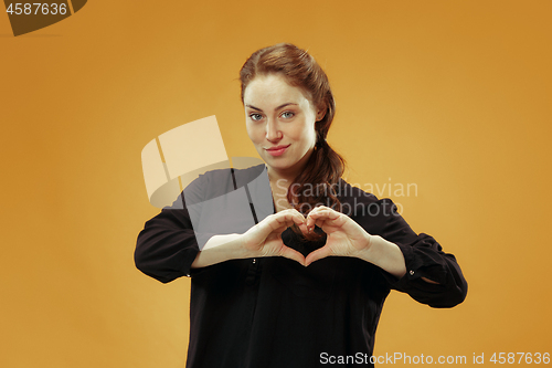 Image of Portrait of attractive cute girl with bright makeup with kiss isolated over studio background