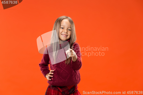 Image of The happy teen girl pointing to you, half length closeup portrait