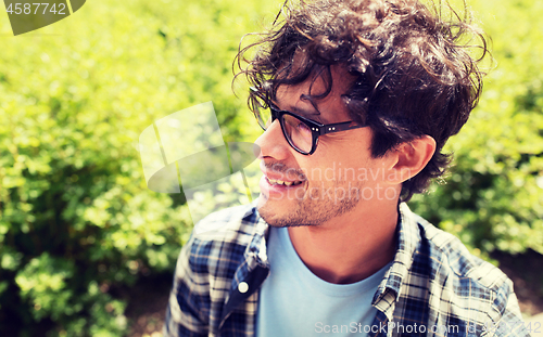 Image of close up of smiling man in eyeglasses outdoors