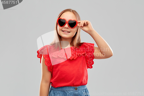 Image of smiling preteen girl with heart shaped sunglasses
