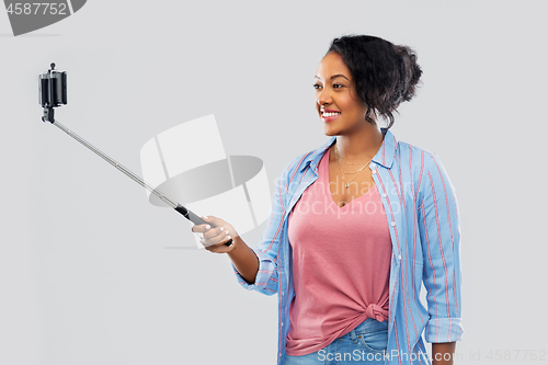 Image of african american woman taking selfie by smartphone