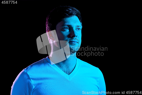 Image of portrait of man over neon lights in dark room