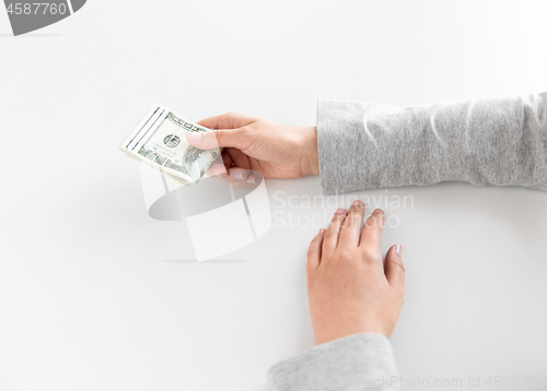 Image of close up of woman hand holding us dollar money