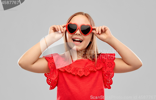 Image of happy preteen girl with heart shaped sunglasses