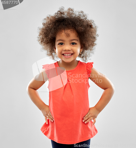 Image of happy little african american girl over grey