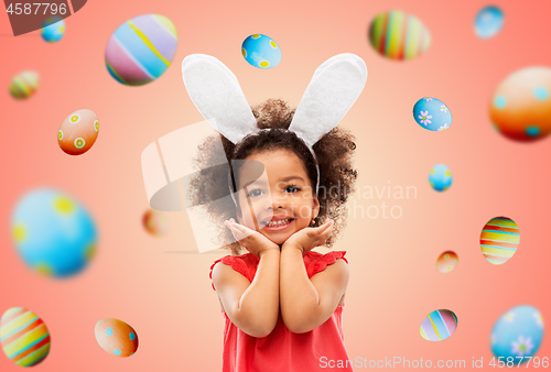 Image of happy little girl wearing easter bunny ears posing